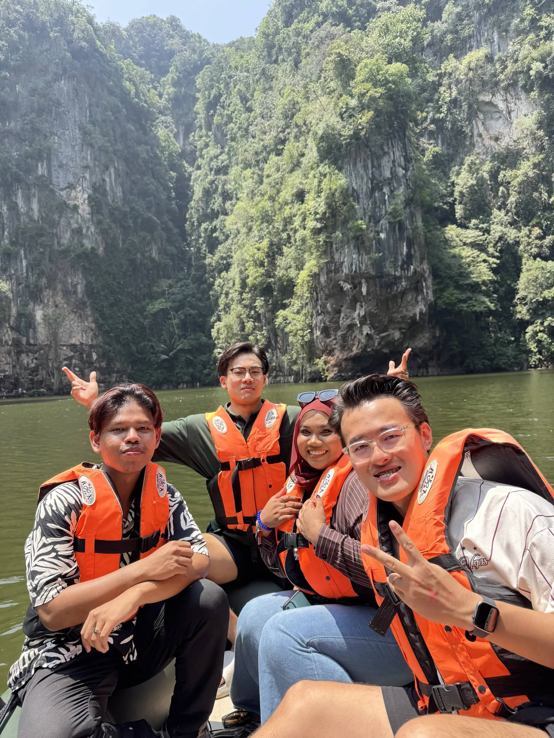 Team rafting in life vests at Tasik Cermin