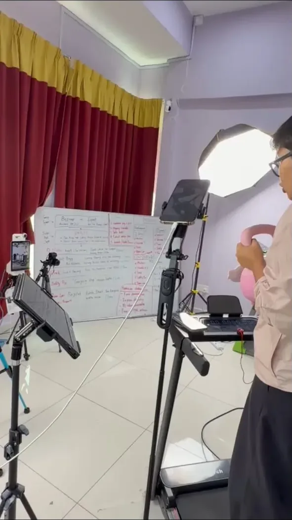 Studio set with a whiteboard run-of-show, ring light and camera rig